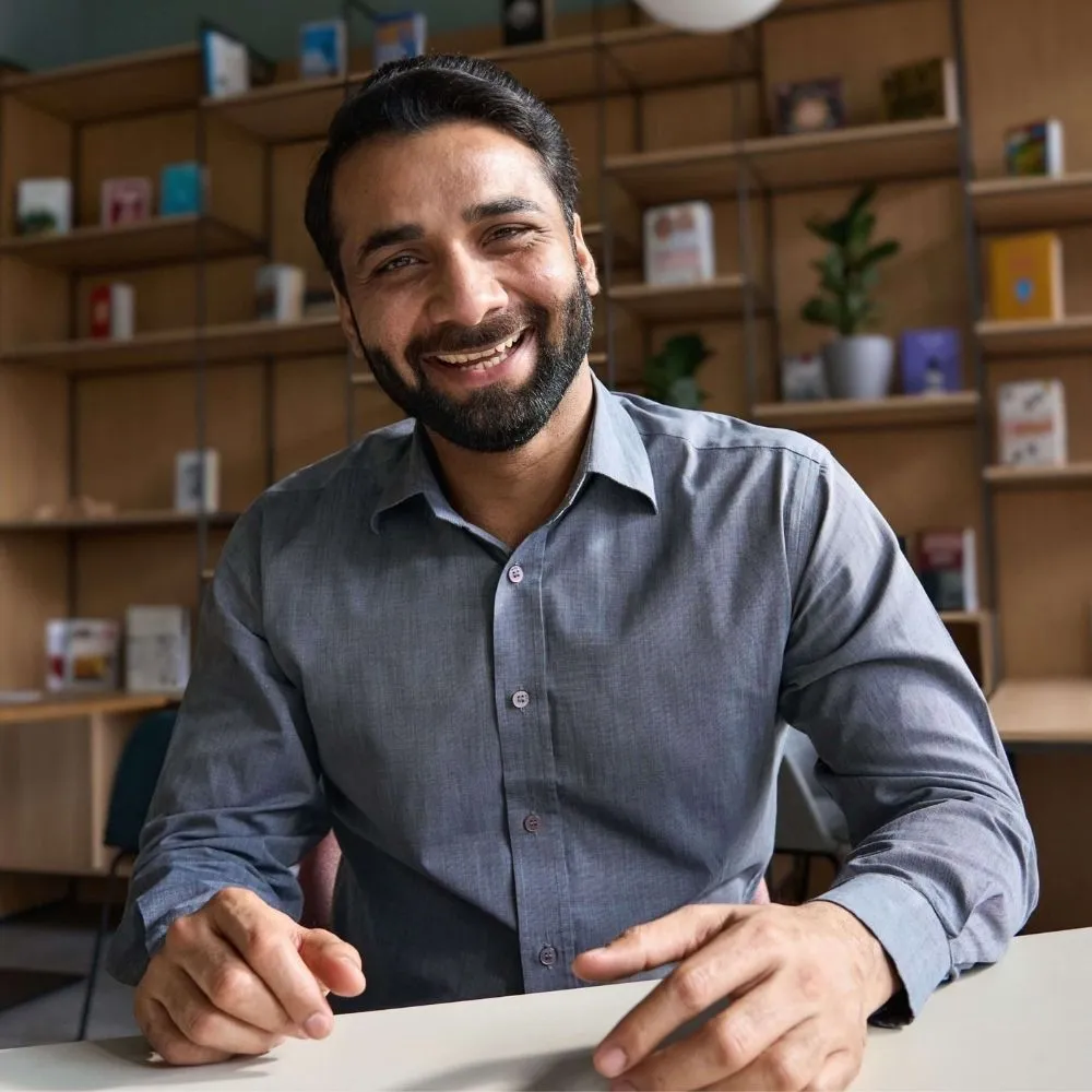 happy-indian-business-man-teacher-talking-to-web-c-U7AGR8C_17.webp